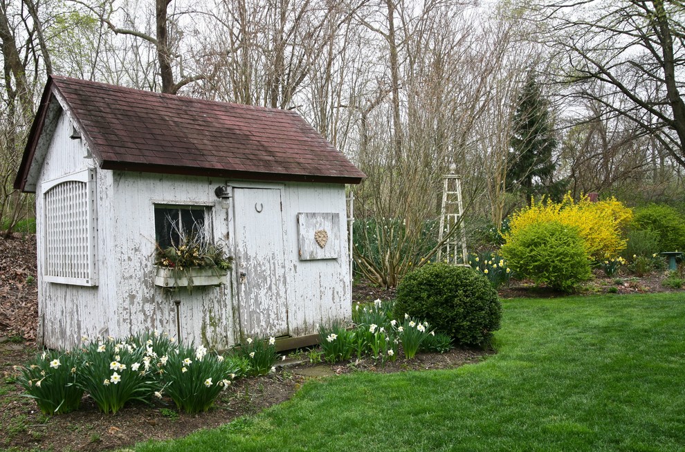 This is an example of a shabby-chic style detached garden shed in Philadelphia.