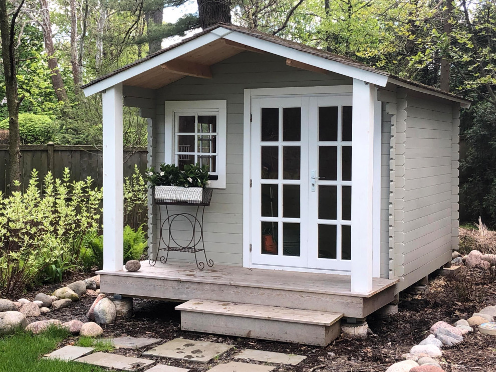 Cottage Storage Shed With Custom Pillars and Patio Craftsman Shed