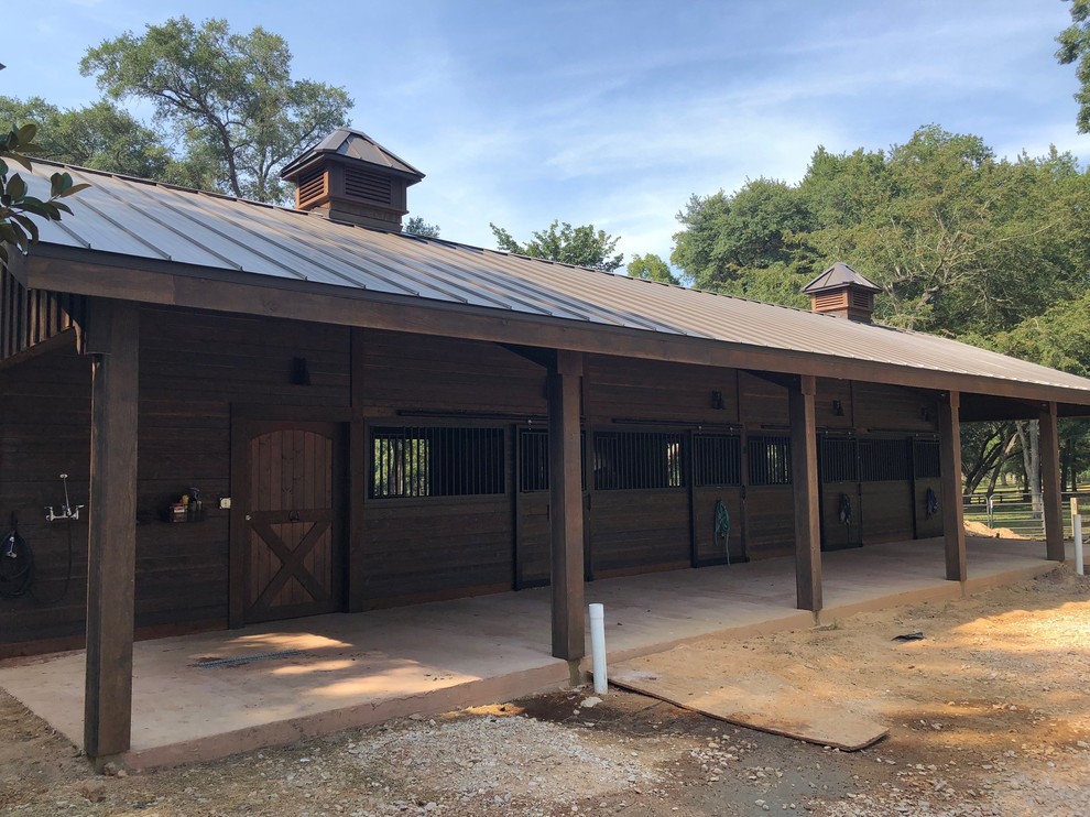 Example of a large mountain style detached barn design in Houston