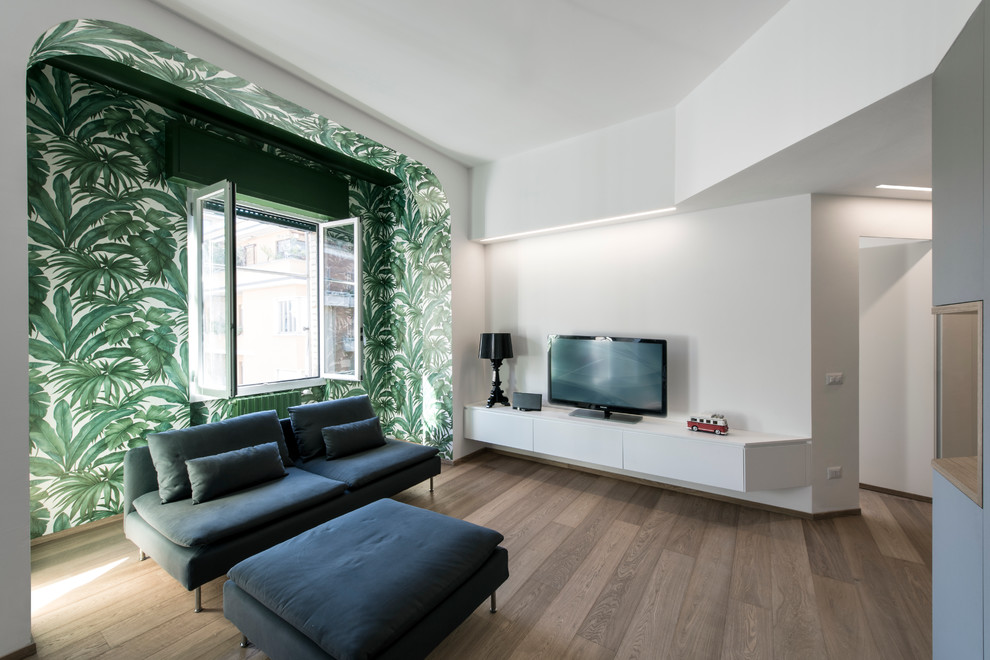 Example of a mid-sized trendy open concept family room design in Milan