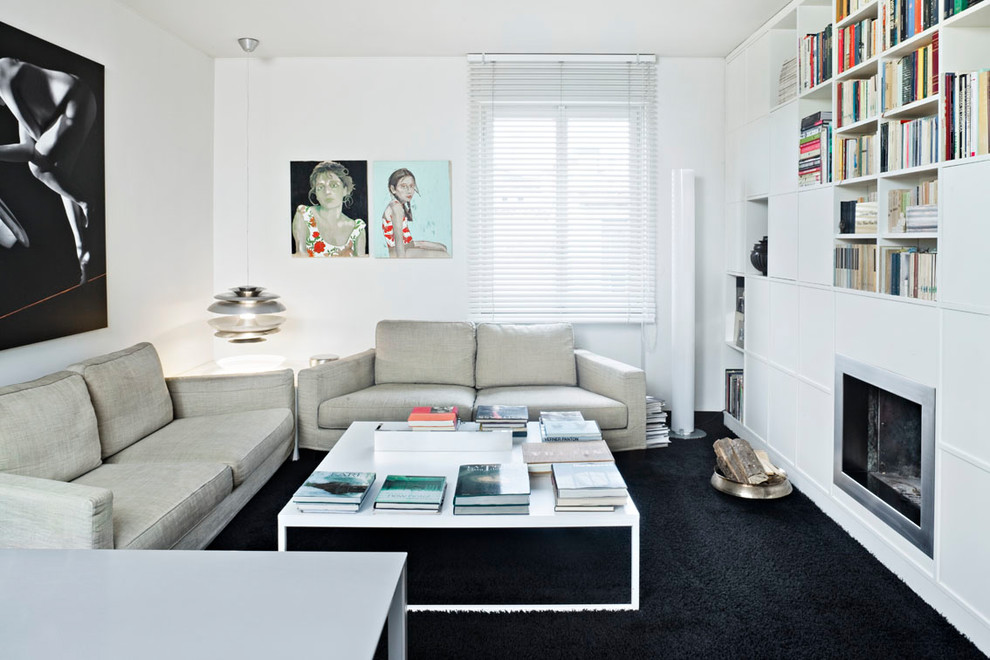 Example of a small trendy enclosed black floor and carpeted living room library design in Milan with white walls, a standard fireplace, a metal fireplace and no tv