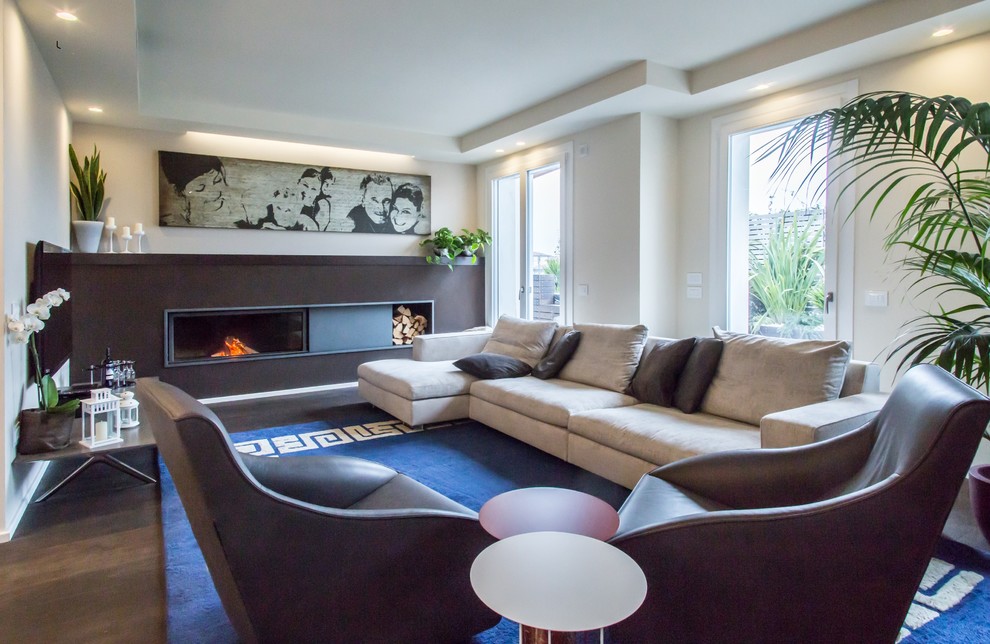 Example of a large trendy formal and enclosed dark wood floor living room design in Bologna with white walls, a ribbon fireplace and a plaster fireplace
