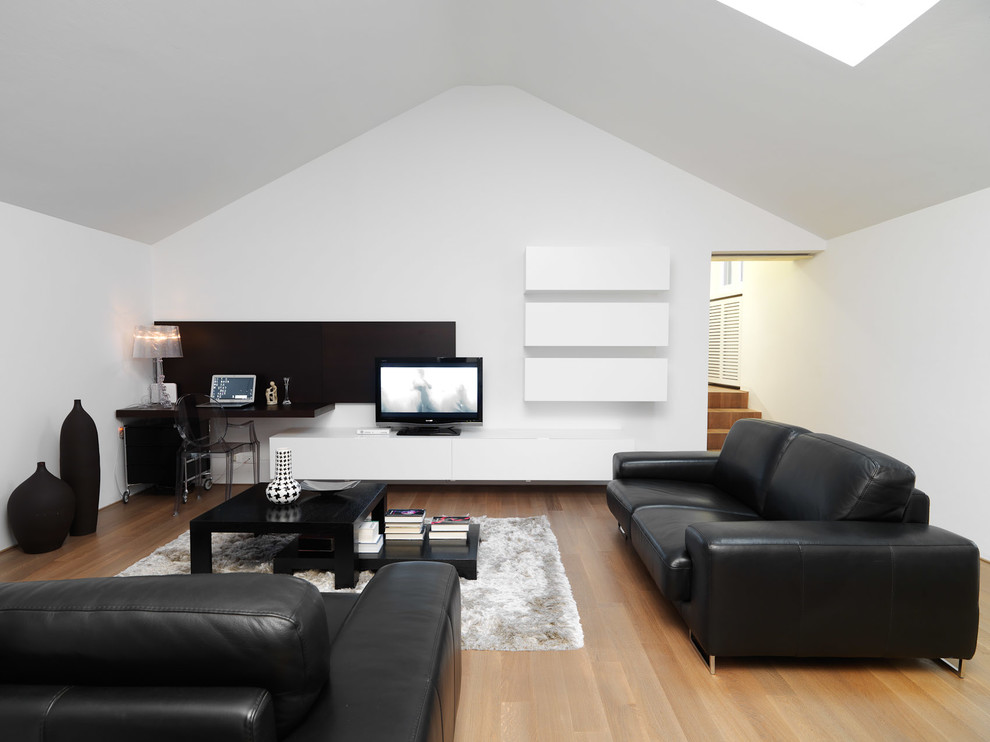 Mid-sized trendy light wood floor family room photo in Turin with white walls and a tv stand