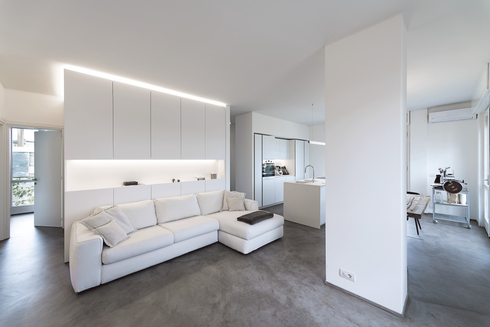 Inspiration pour un grand salon design ouvert avec un mur blanc et un sol gris.