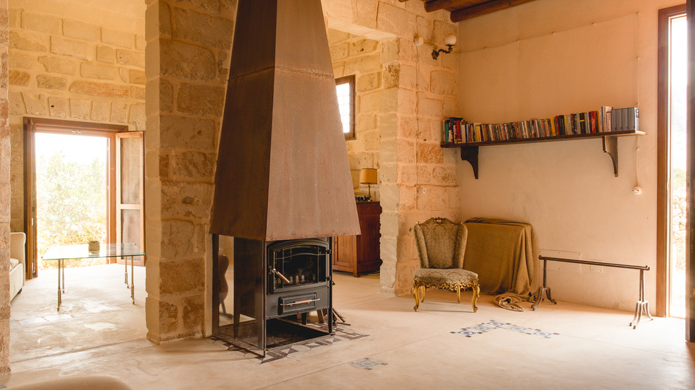 Cette photo montre une salle de séjour méditerranéenne avec un mur beige et un poêle à bois.