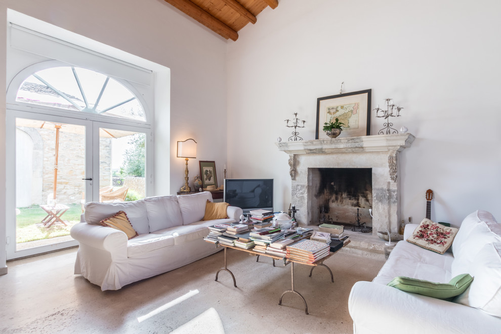 Design ideas for a large farmhouse enclosed living room in Catania-Palermo with white walls, a standard fireplace, a stone fireplace surround and a freestanding tv.