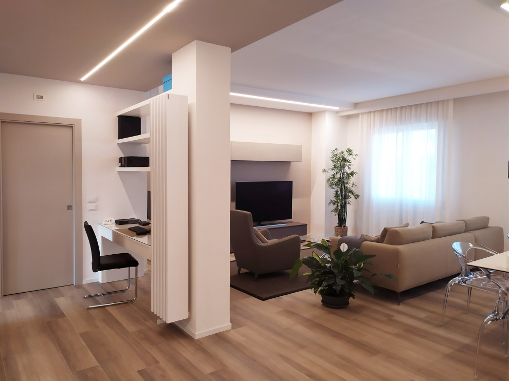 Photo of an expansive contemporary open plan living room in Florence with a reading nook, white walls, porcelain flooring, a built-in media unit and beige floors.