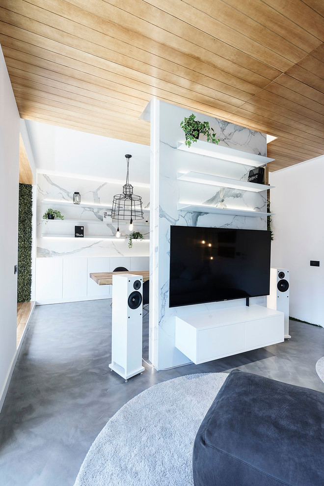 Idee per un soggiorno design di medie dimensioni e aperto con pareti bianche, pavimento in cemento e pavimento grigio