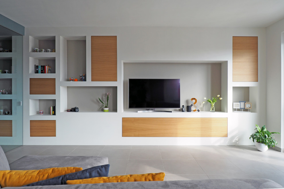 Design ideas for a medium sized modern open plan living room in Turin with a reading nook, white walls, ceramic flooring, a wall mounted tv and grey floors.