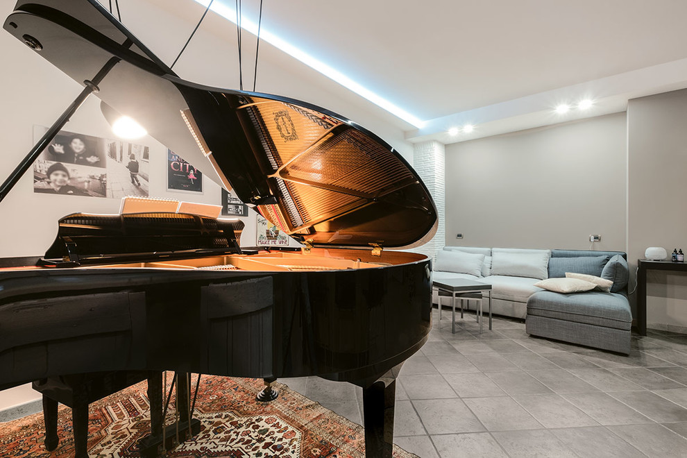 Immagine di un piccolo soggiorno minimal chiuso con sala della musica, pareti grigie, pavimento in gres porcellanato e pavimento grigio