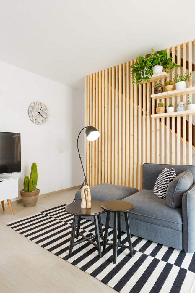 Small scandi open plan games room in Rome with white walls, light hardwood flooring and beige floors.