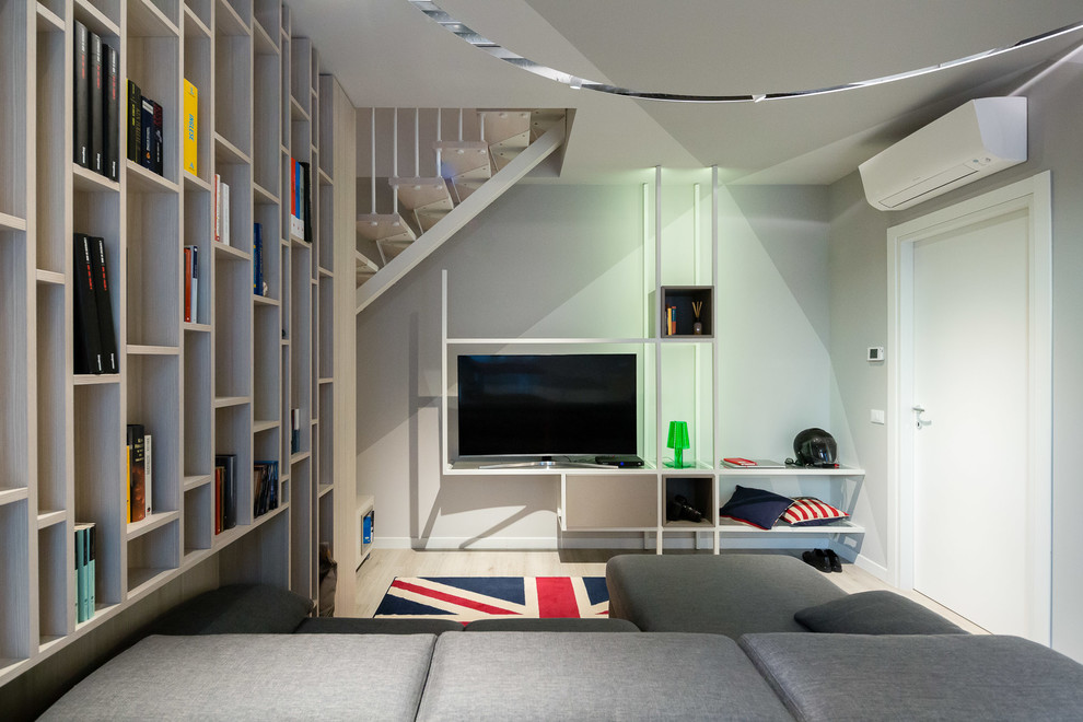 Immagine di un soggiorno design di medie dimensioni e aperto con angolo bar, pareti bianche, pavimento in legno massello medio, TV a parete e pavimento grigio