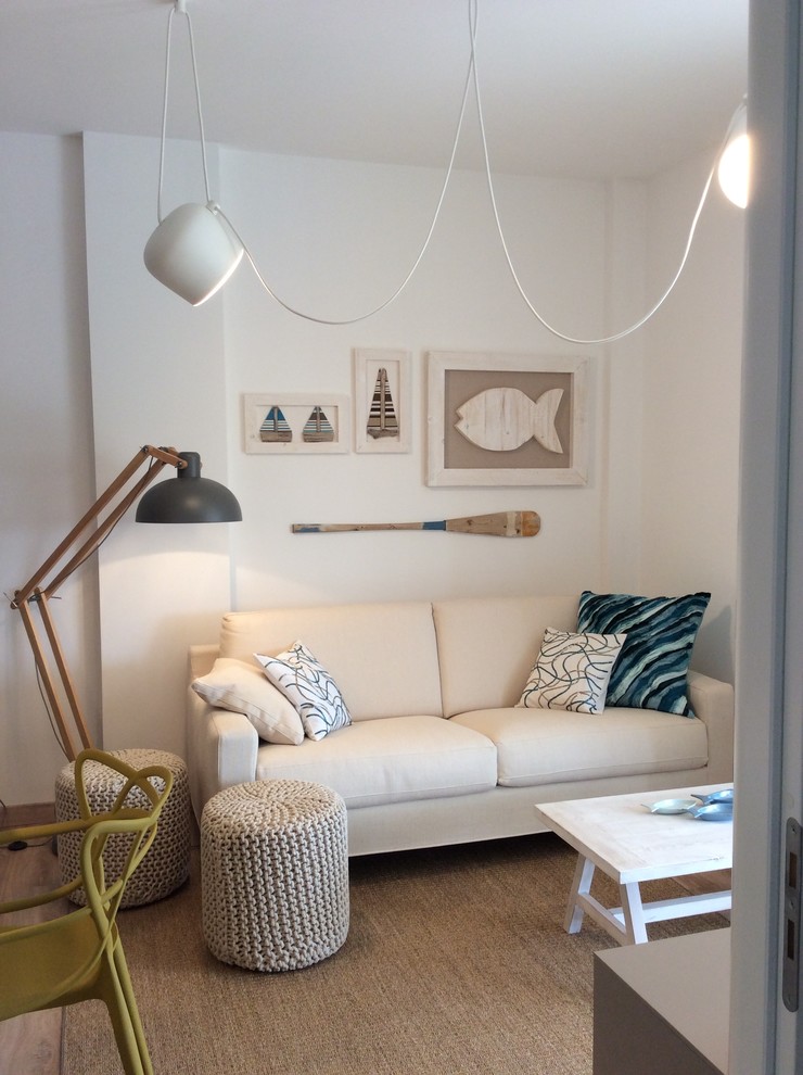 Example of a small danish enclosed family room design in Milan with white walls