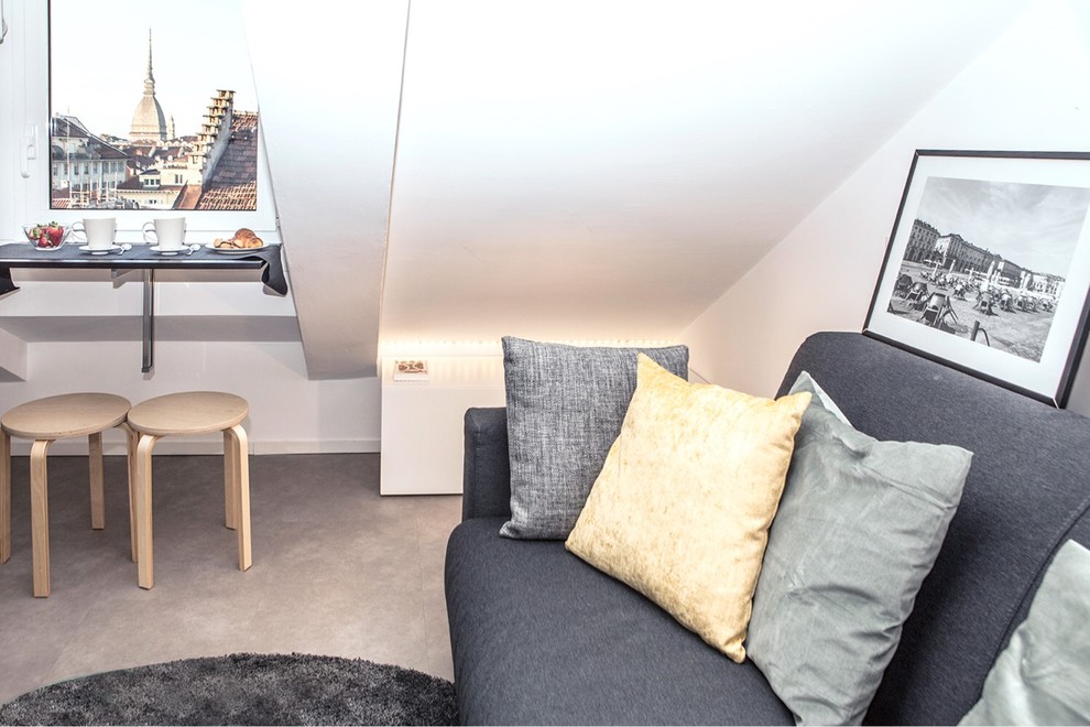 Esempio di un piccolo soggiorno design aperto con pareti bianche, pavimento in cemento e pavimento beige