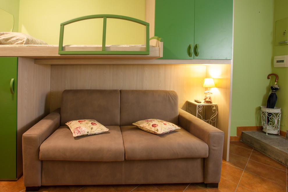 Example of a small trendy loft-style family room design in Rome with green walls and a wall-mounted tv