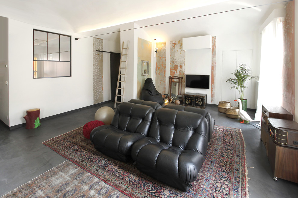 Modelo de salón para visitas abierto ecléctico de tamaño medio con paredes blancas, suelo de cemento, televisor colgado en la pared y suelo gris