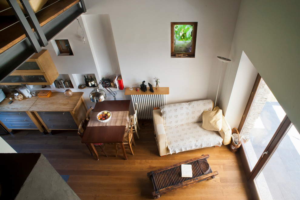 Esempio di un soggiorno country di medie dimensioni e aperto con pavimento in legno verniciato