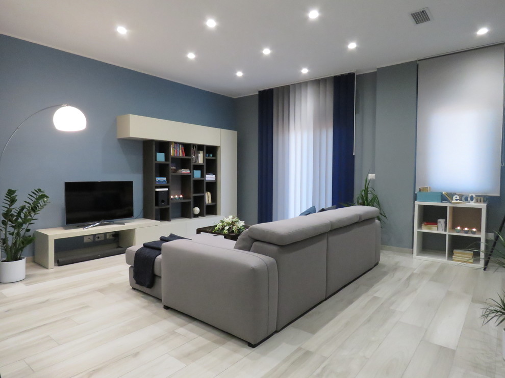 Photo of a small modern open plan living room in Catania-Palermo with grey walls, porcelain flooring, no fireplace, a freestanding tv and beige floors.