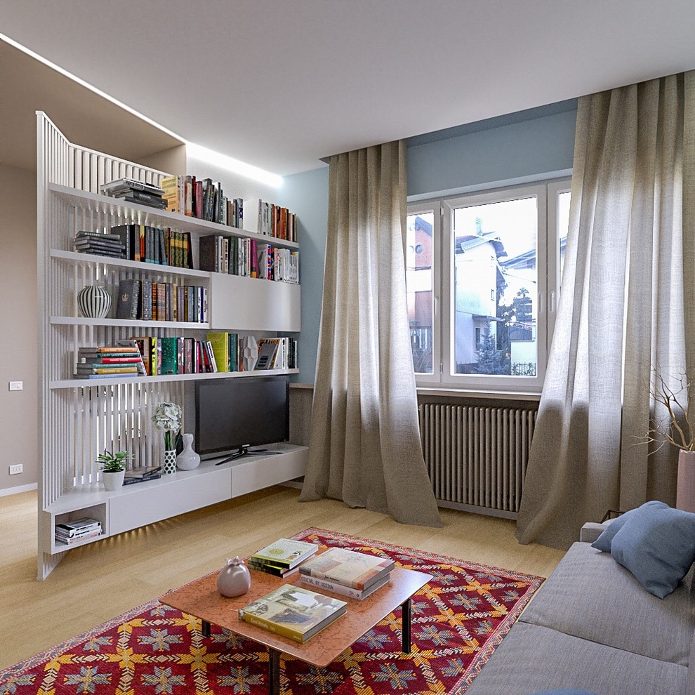 Esempio di un soggiorno minimal di medie dimensioni e aperto con libreria, pareti blu, parquet chiaro e parete attrezzata