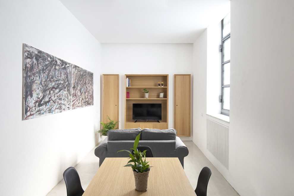Idee per un piccolo soggiorno design stile loft con parete attrezzata e pavimento grigio