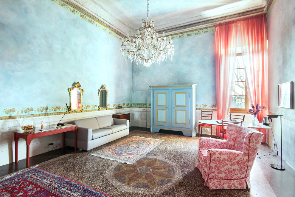 Foto de salón bohemio con paredes azules y suelo multicolor
