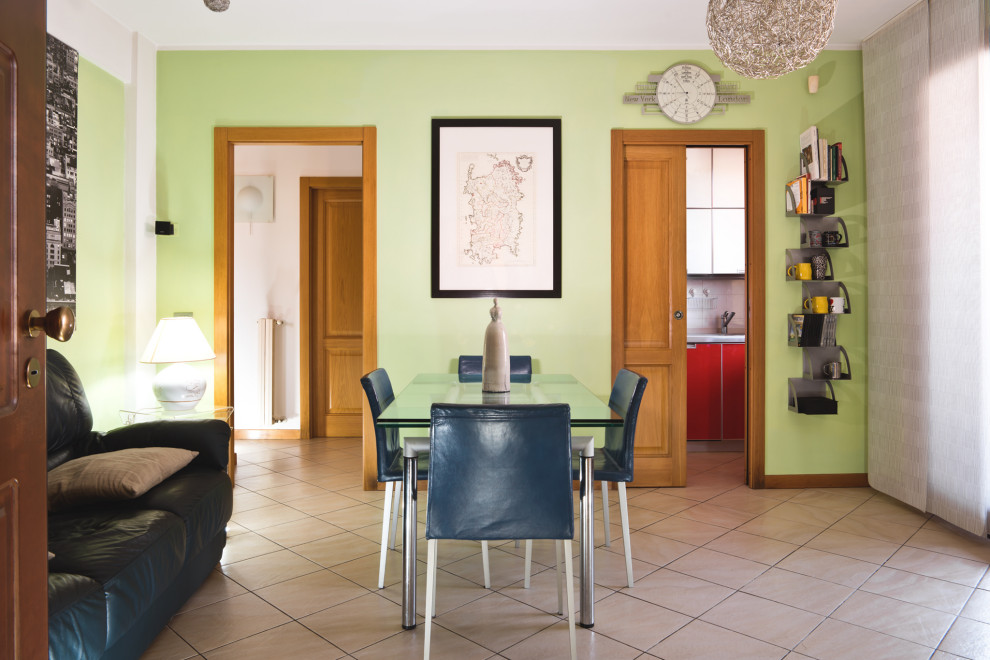 This is an example of a small modern dining room in Florence with green walls, ceramic flooring and beige floors.