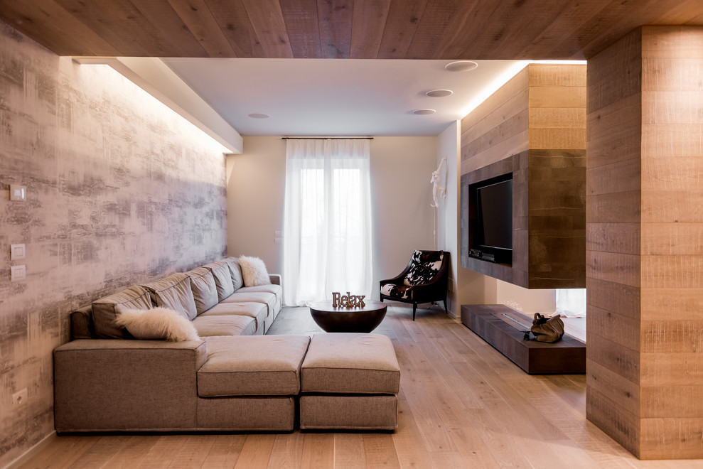 Design ideas for a contemporary games room in Other with light hardwood flooring, a two-sided fireplace, a wall mounted tv, beige floors, multi-coloured walls and a feature wall.