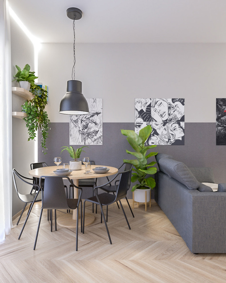 Esempio di un piccolo soggiorno industriale aperto con pareti grigie, parquet chiaro e TV a parete
