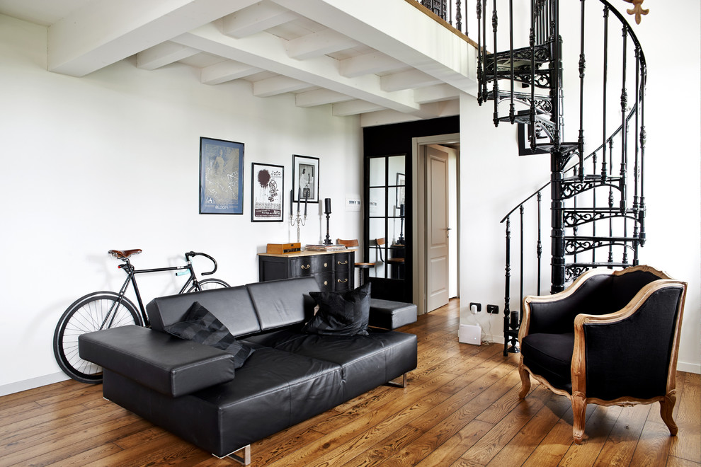 Family room - mid-sized eclectic medium tone wood floor family room idea in Milan with white walls