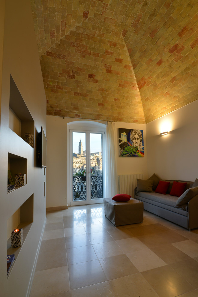 Inspiration for a contemporary open plan games room in Rome with white walls, a wall mounted tv and beige floors.