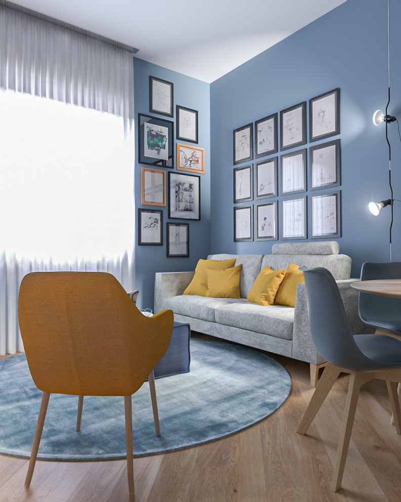 Design ideas for a medium sized contemporary open plan living room in Milan with a reading nook, blue walls, light hardwood flooring, a concealed tv and a drop ceiling.