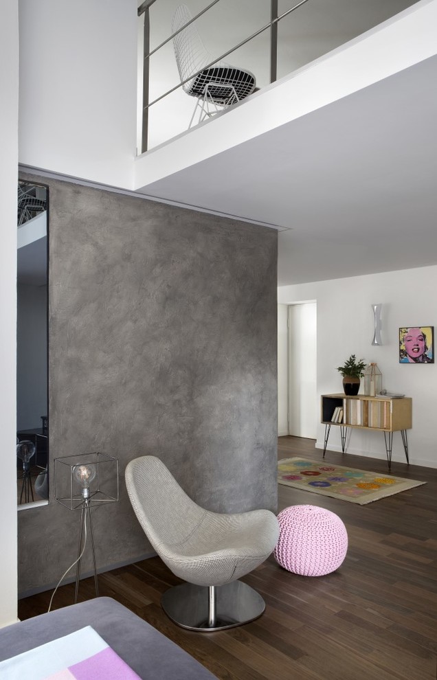 Contemporary mezzanine living room in Turin with grey walls, medium hardwood flooring and brown floors.