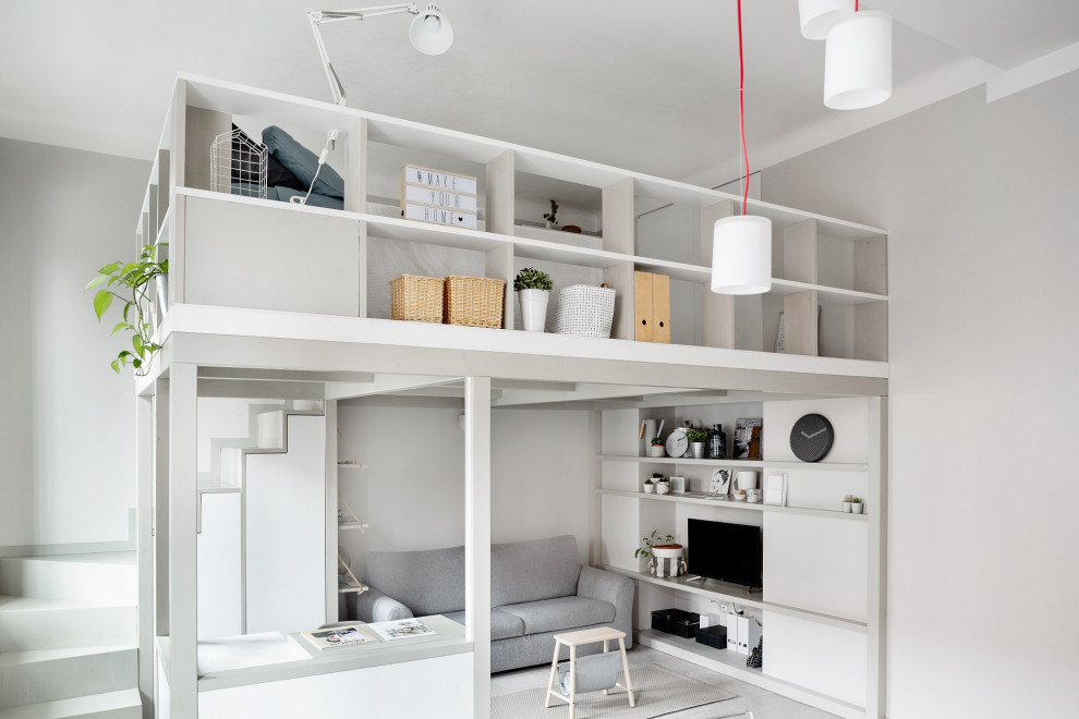 Esempio di un piccolo soggiorno nordico stile loft con libreria, pareti grigie, pavimento in gres porcellanato, TV autoportante e pavimento grigio