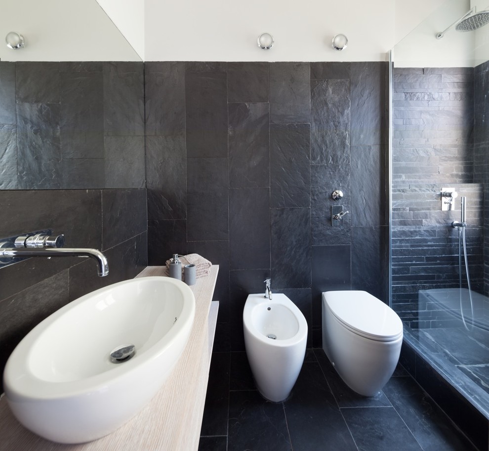 Immagine di una stanza da bagno padronale minimal di medie dimensioni con ante in legno chiaro, doccia aperta, piastrelle nere, piastrelle in ardesia, pareti nere, pavimento in ardesia, lavabo a bacinella e pavimento nero