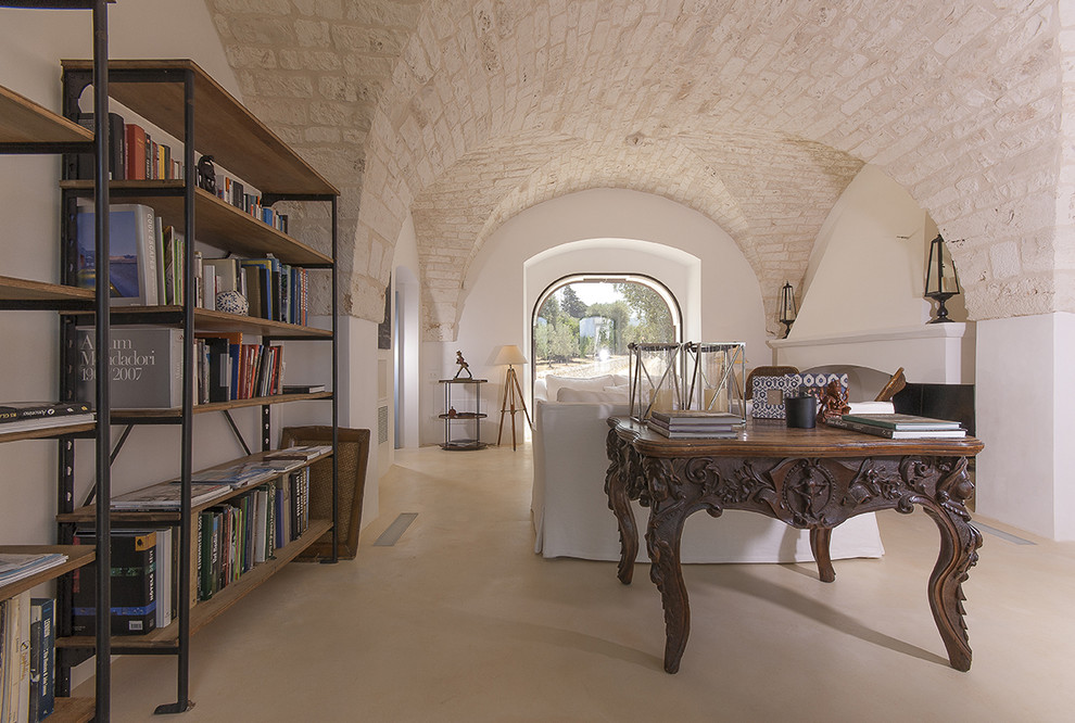 Example of a large tuscan open concept family room design in Bari with white walls, a standard fireplace and a plaster fireplace