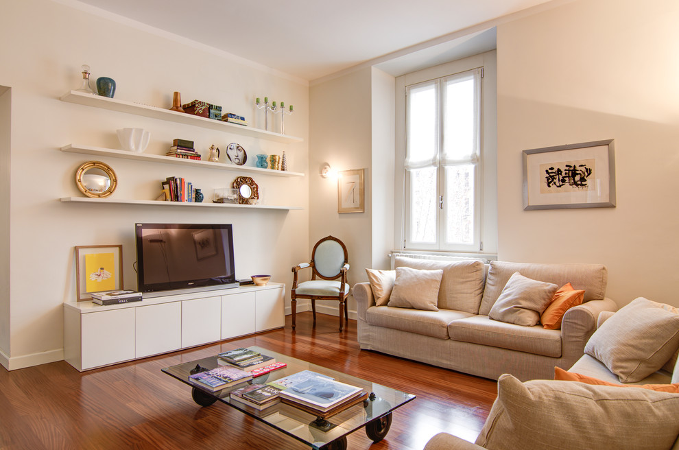 Großes Modernes Wohnzimmer ohne Kamin mit braunem Holzboden, freistehendem TV und weißer Wandfarbe in Mailand
