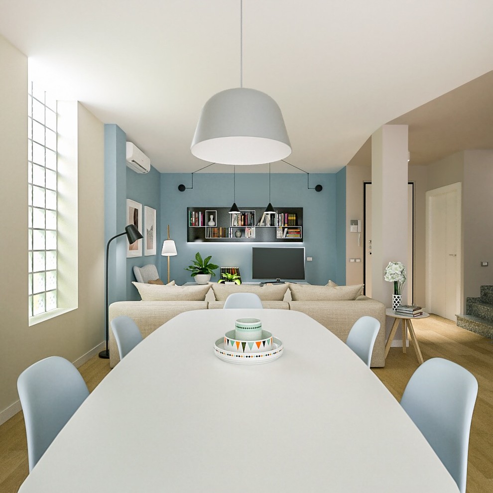 Photo of a medium sized contemporary dining room in Milan with blue walls and light hardwood flooring.