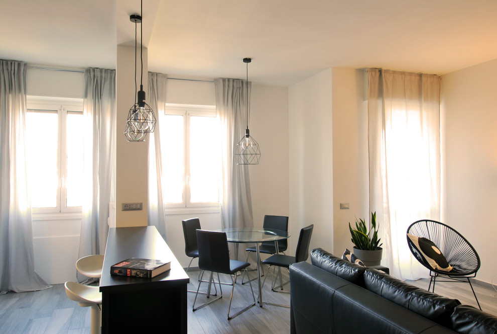 Immagine di un ampio soggiorno minimal aperto con pareti bianche, pavimento in gres porcellanato e pavimento grigio