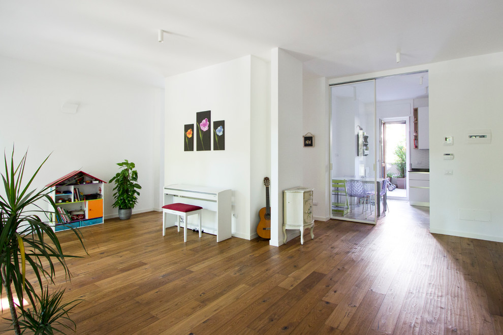 Large contemporary open plan living room in Milan with white walls and light hardwood flooring.