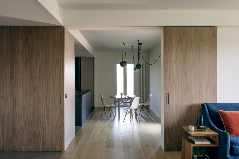 Стильный дизайн: гостиная комната в современном стиле с белыми стенами и светлым паркетным полом - последний тренд