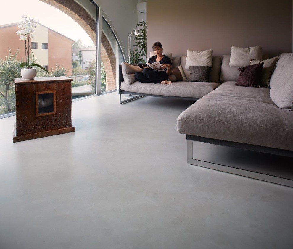 Foto di un soggiorno contemporaneo con pavimento in cemento
