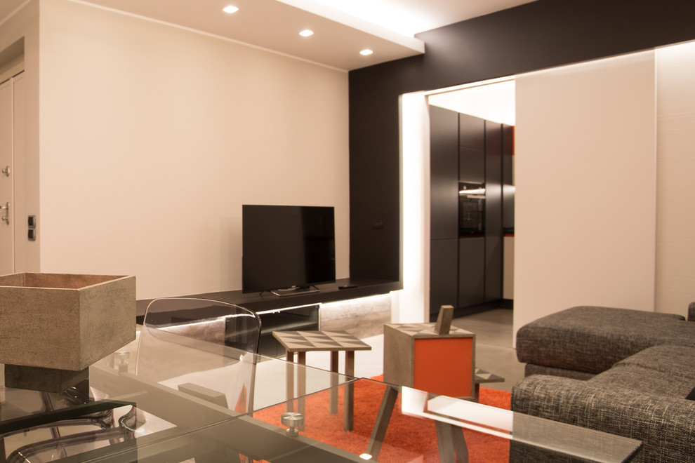 Свежая идея для дизайна: изолированная гостиная комната среднего размера в современном стиле с серыми стенами, бетонным полом и мультимедийным центром - отличное фото интерьера