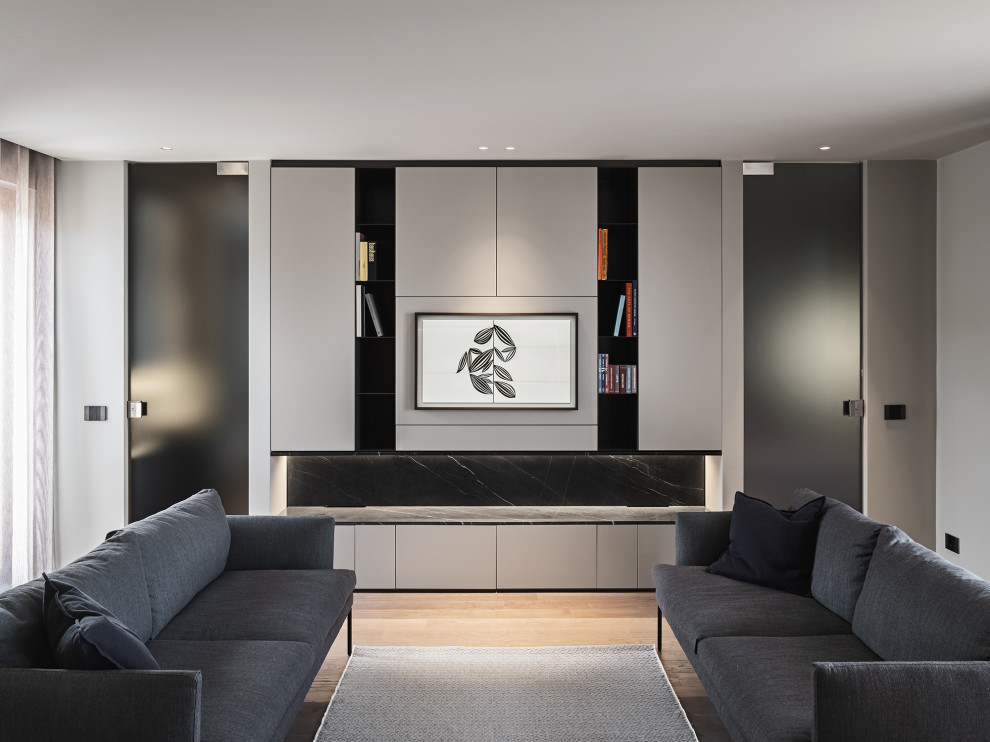 This is an example of a small contemporary open plan games room in Bari with a reading nook, grey walls, a wall mounted tv, grey floors and a drop ceiling.