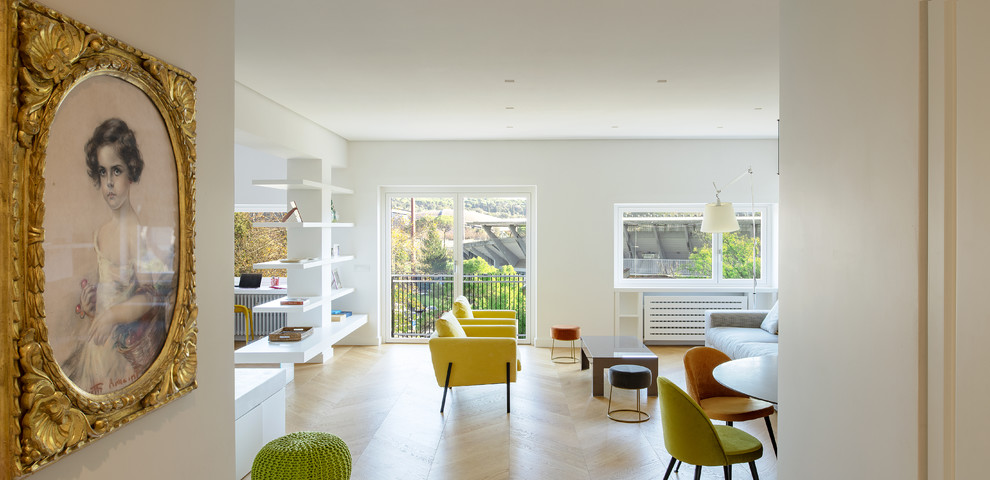 This is an example of a contemporary family room in Rome with light hardwood floors.