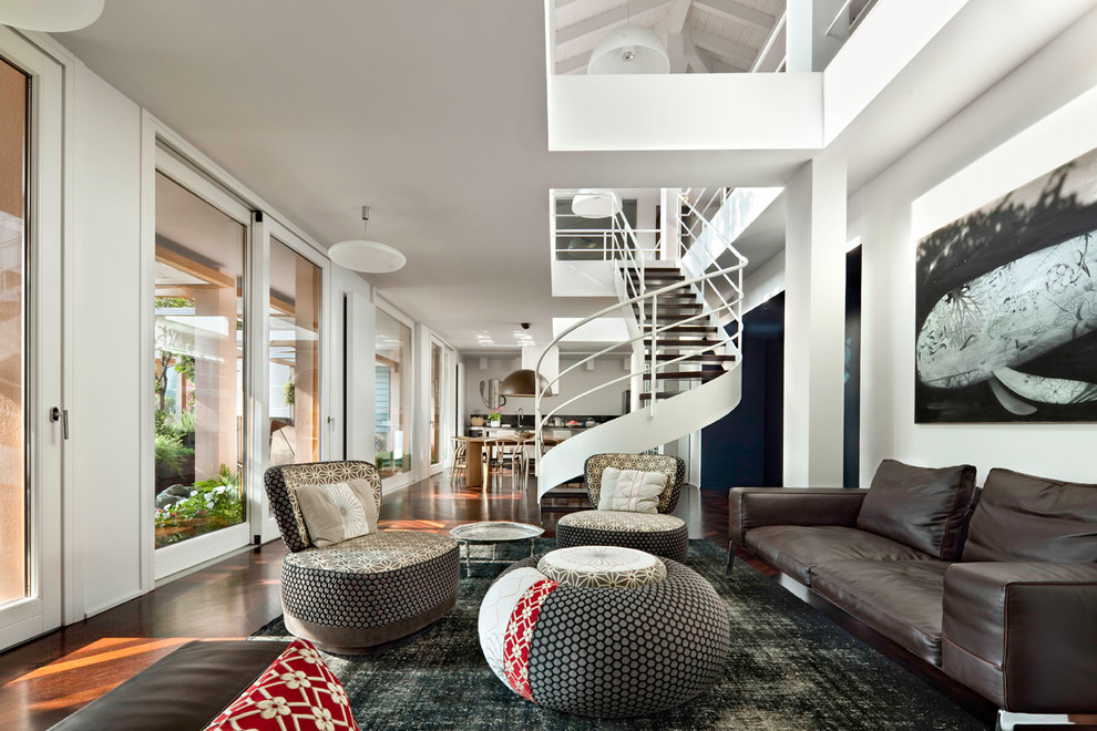Immagine di un ampio soggiorno design stile loft con pareti bianche e parquet scuro