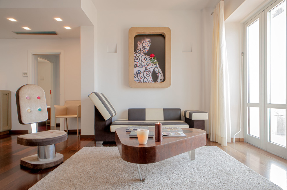 Aménagement d'un grand salon contemporain avec un mur blanc et un sol en bois brun.