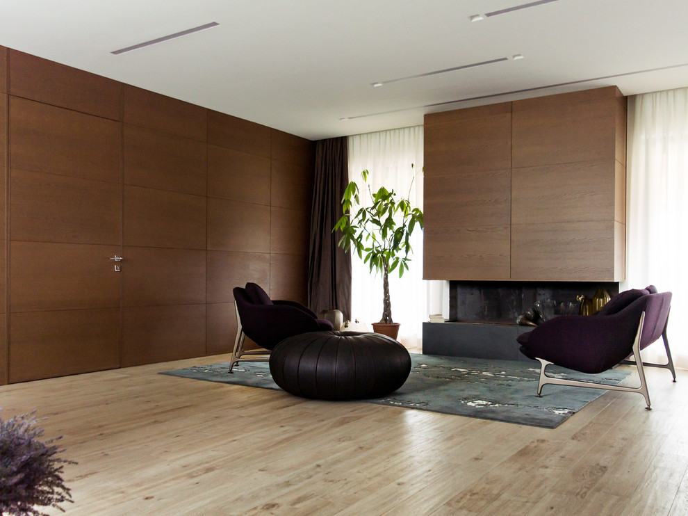 Example of a mid-sized trendy enclosed porcelain tile, beige floor and wainscoting family room design in Other with white walls and a wood fireplace surround