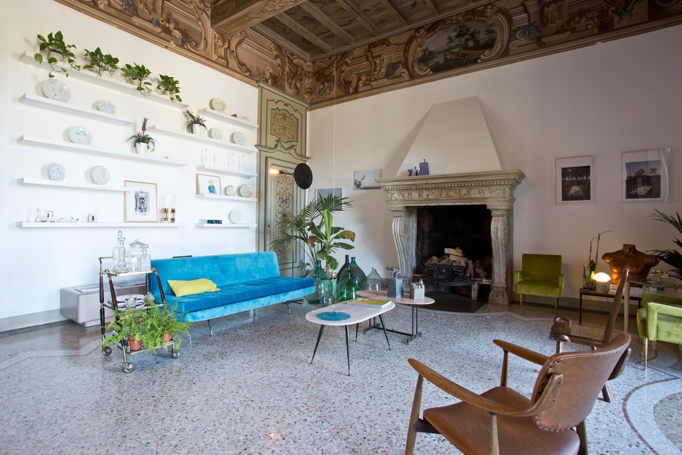 Example of a large eclectic enclosed family room design in Milan with white walls, a standard fireplace and a stone fireplace