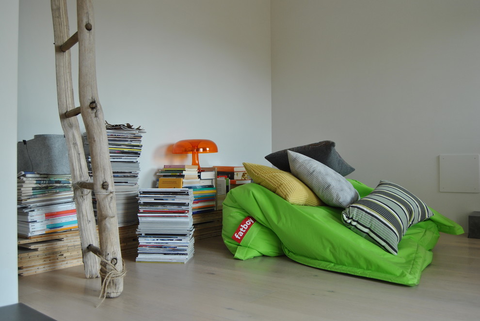 Kleines, Offenes Modernes Wohnzimmer mit weißer Wandfarbe, hellem Holzboden und beigem Boden in Mailand