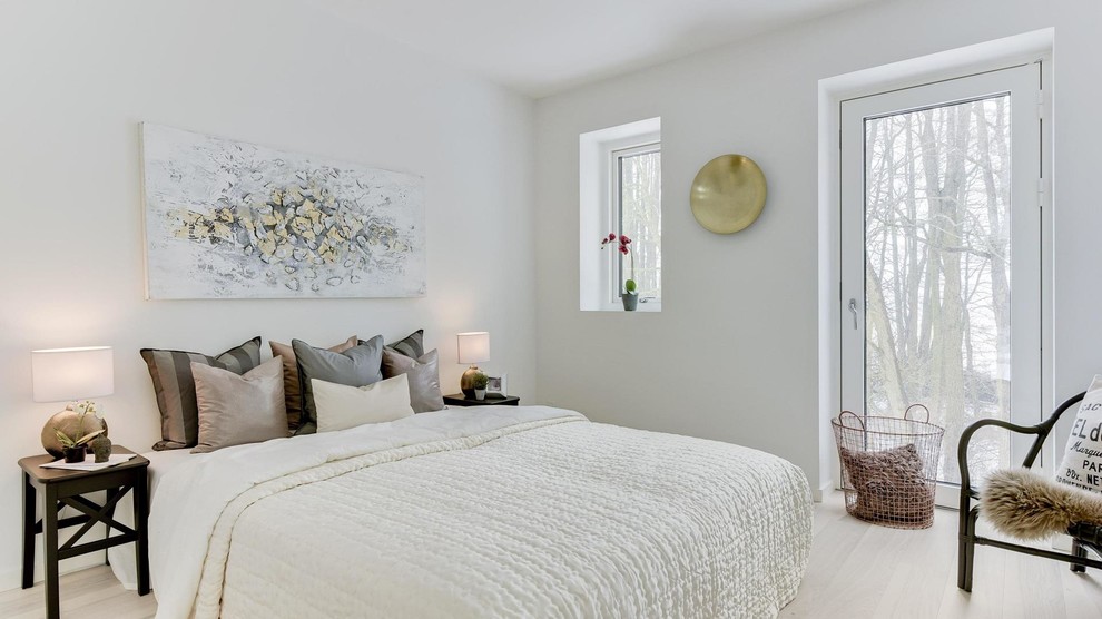 Bedroom - mid-sized contemporary guest light wood floor and beige floor bedroom idea in Copenhagen with white walls